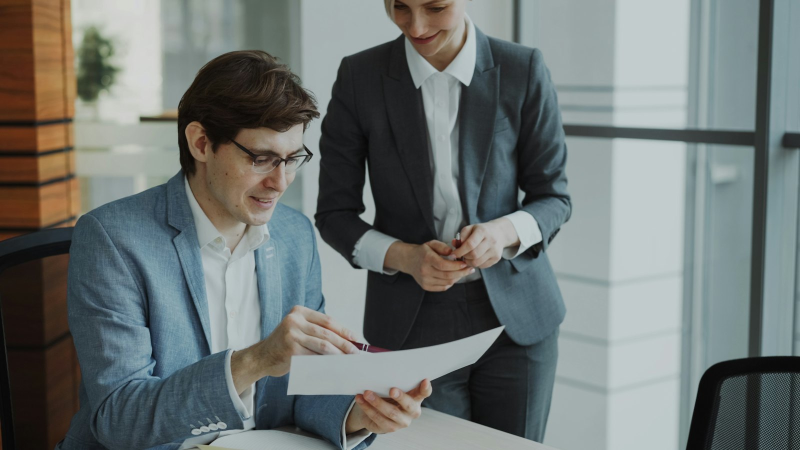 Two professionals reviewing documents at a desk